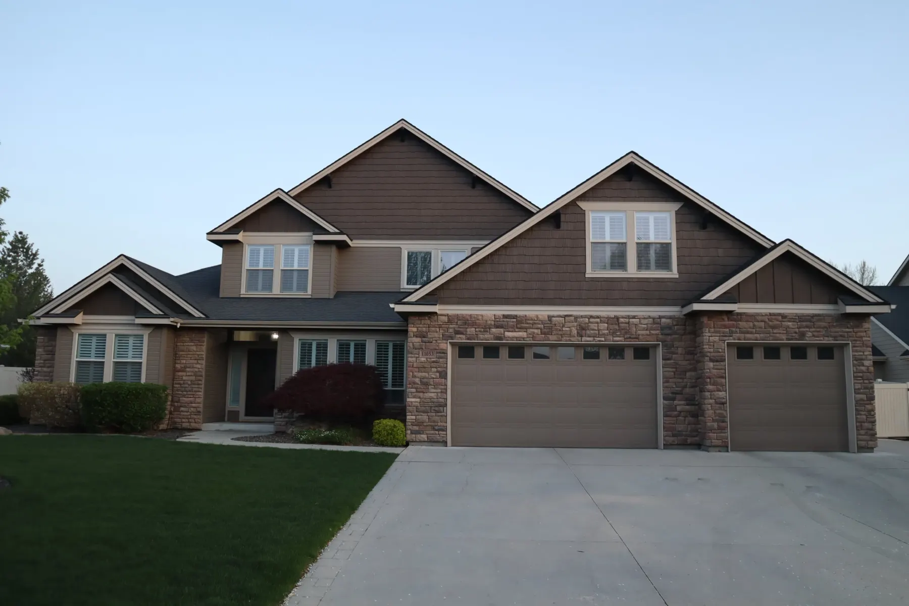 Townhouse row with soffit-mounted LED track lighting in warm white, showing exterior lighting on a shared-wall property