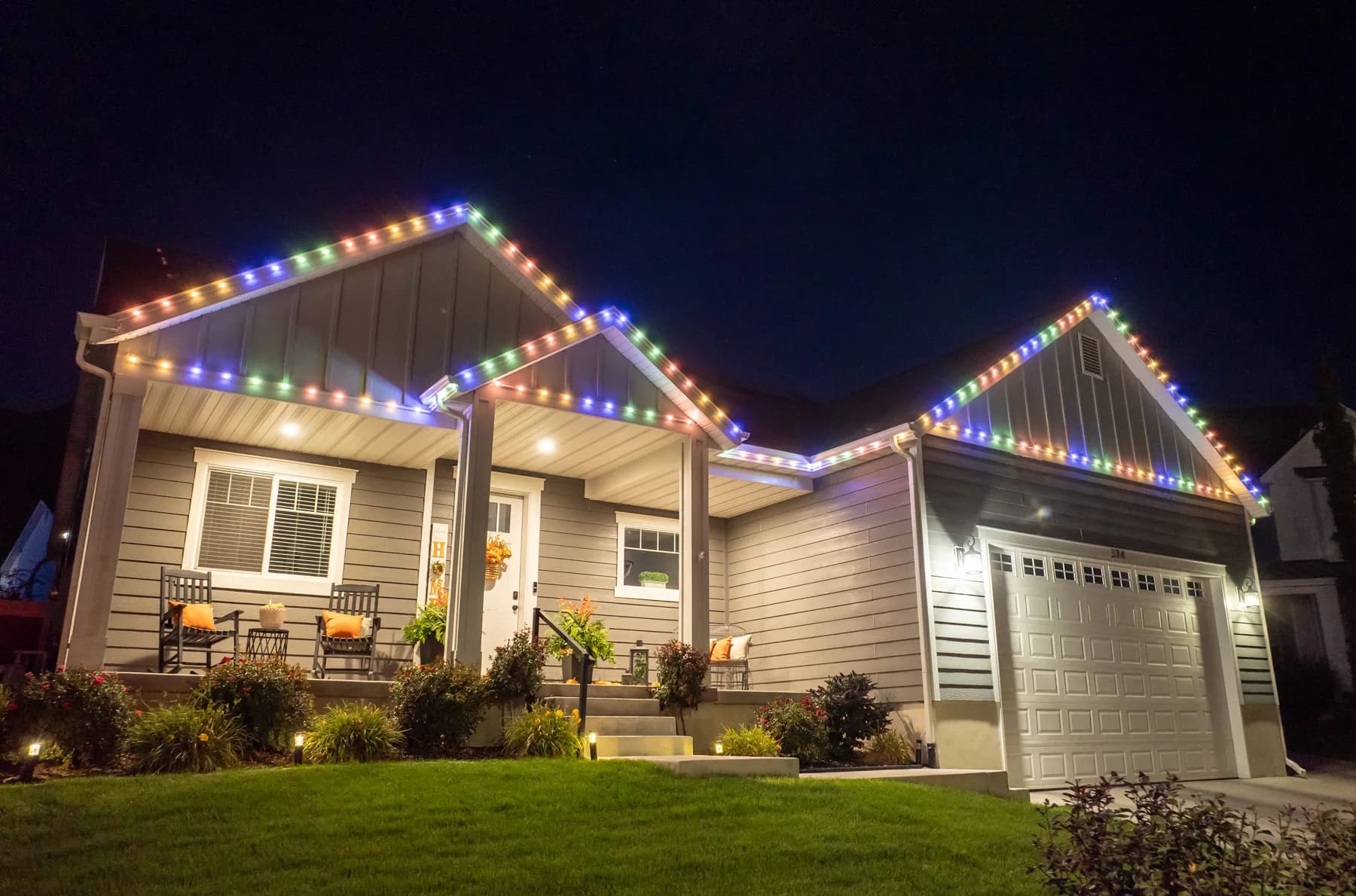 Technician installing permanent LED soffit track lighting on a Southwestern Ontario home